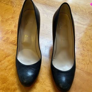 Pair of classic black rounded toe Louboutin heels.